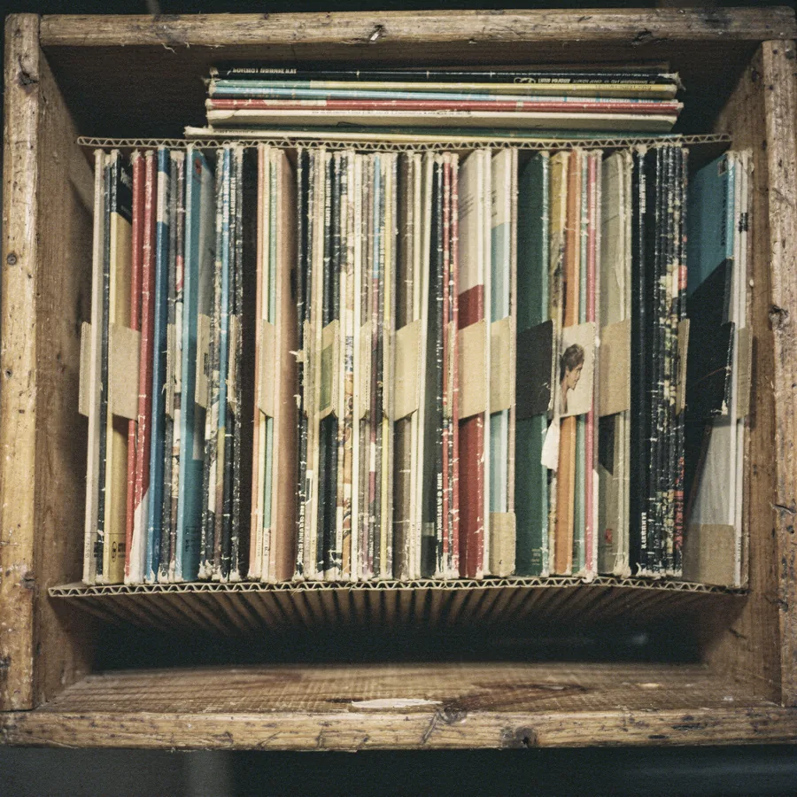Looking down into a wooden crate packed with vinyl LPs