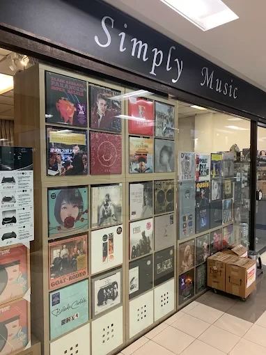 The Simply Music shopfront at The Adelphi, Singapore, with a wall of record sleeves behind glass